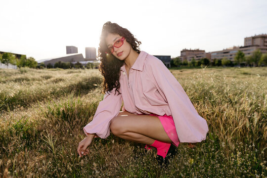 Woman with curly hair in golden hour light