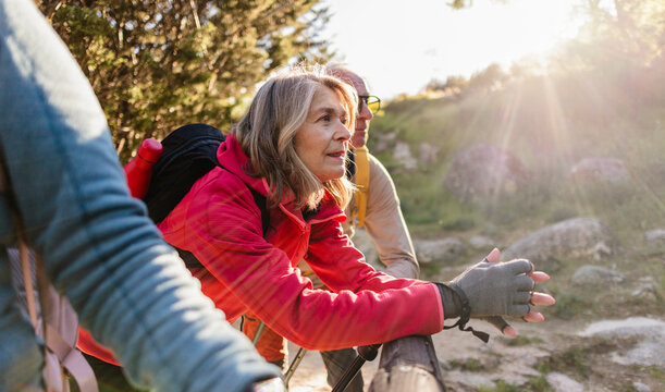 Senior woman hiking enjoying sunny outdoor adventure in nature