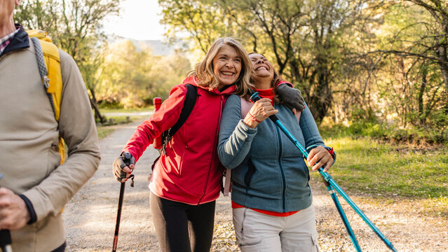 Senior women friends enjoying active hiking adventure in nature