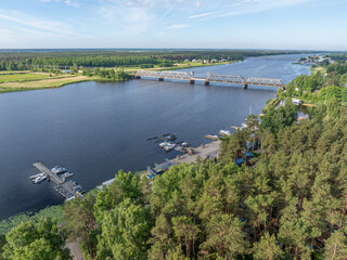 Fototapeta premium Aerial view of the railway bridge over the Lielupe River in Jurmala, Latvia on a sunny summer day