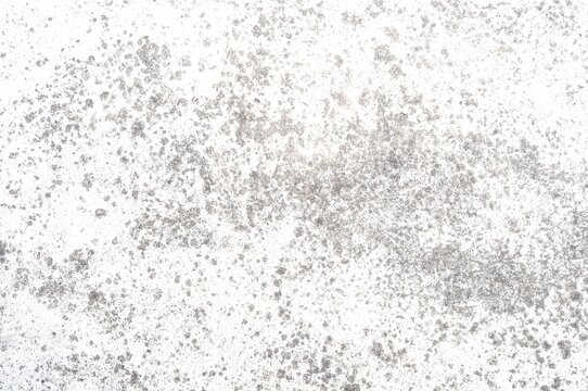 Light gray concrete or stone texture background with scattered speckles and grunge distressed pattern on white surface, abstract backdrop with copy space.