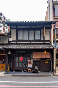 Kyoto, Japan - April 20, 2025 Traditional Japanese townhouse storefront with wooden facade and restaurant entrance, showcasing local culture, heritage architecture, and urban street atmosphere