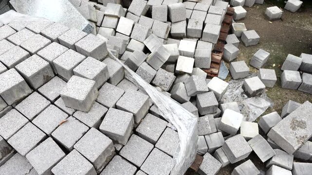 Concrete paving blocks stacked at construction site used for sidewalk and urban paving works
