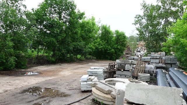 Outdoor storage of concrete paving slabs and curbstones at construction site for urban infrastructure and landscaping works