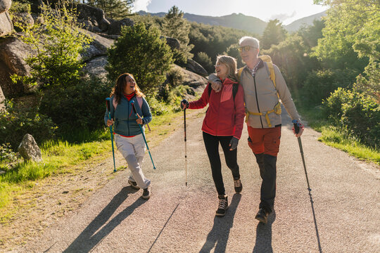 Senior friends enjoying hiking trip in sunny nature