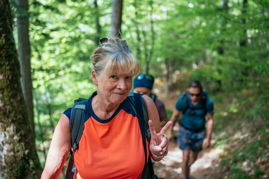 Smiling grandmother showing peace sign
