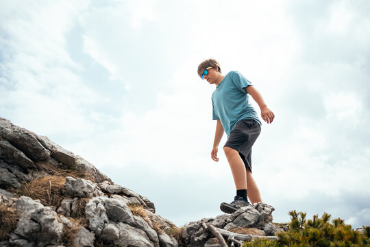 Boy hiking on mountain ridge