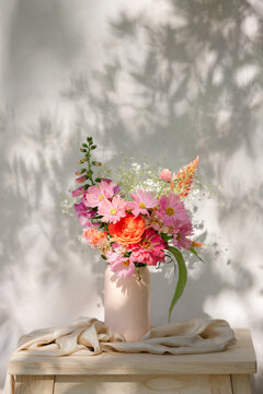 Bright flower still life on dappled light backdrop