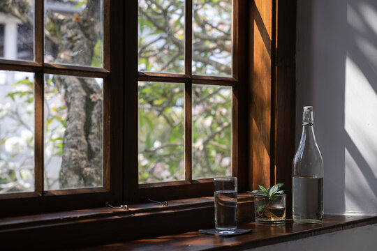 Water bottle and glass on a windowsill