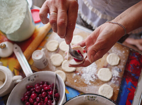 Making cherry dumplings, also known as Varenyky