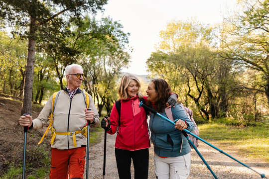 Diverse senior friends enjoying nature hiking together