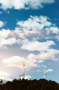 Wind Turbines Stand Tall Against Cloudy Backdrop