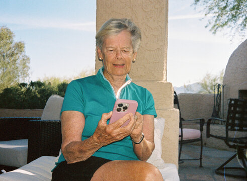 Senior woman Portrait  texting cell phone outdoors film
