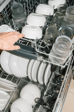 Dishwasher filled with clean dishes and glassware