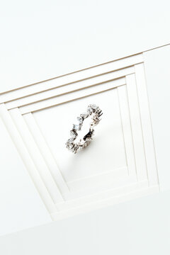 Elegant Silver Floral Eternity Band Ring on Minimalist White Geometric