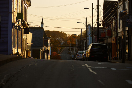 Lunenburg, NS street during sunrise with buildings lining the road