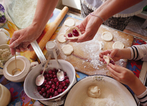 Making cherry dumplings, also known as Varenyky