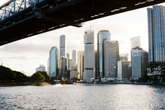 Brisbane skyline gleaming under golden sunlight