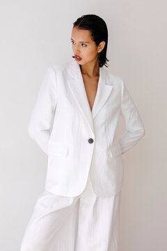 Woman modeling white linen suit
