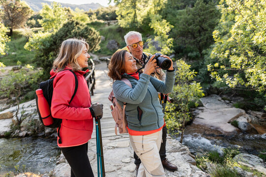 Senior friends enjoying nature exploring and photographing