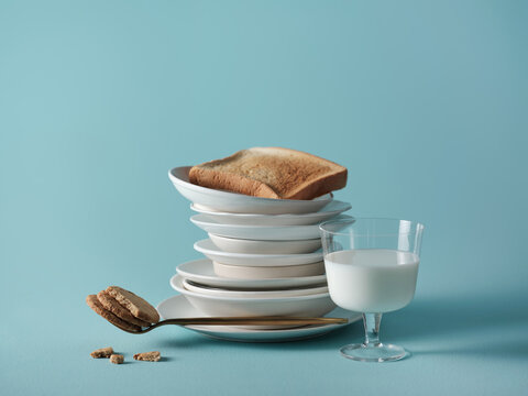 Breakfast still life with toast, milk, and cookies on blue background