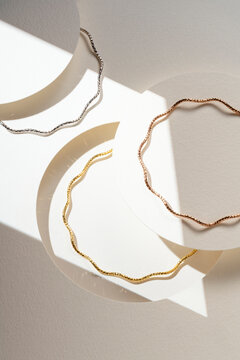 Minimalist Wavy Bangle Bracelets on Abstract Geometric Background