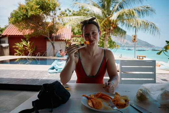 Enjoying mango by the pool on a sunny beach day
