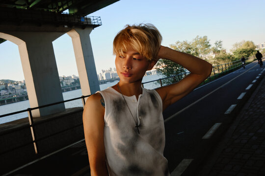Young man posing by Hangang River bike path in Seoul