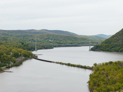 Suspension Bridge Over River Between Green Hills