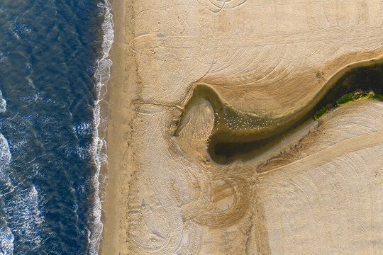 Coastal lagoon landlocked by a sandy beach alongside the sea