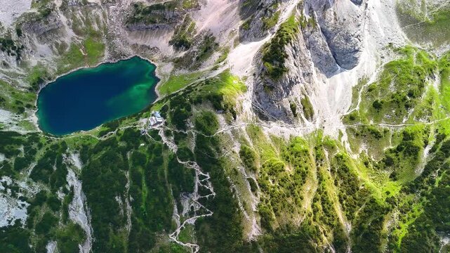 Aerial drone view of the Alps and the green Seebensee on a sunny summer day. A couple enjoys the view of Seebensee and goes hiking. Seebenlake	