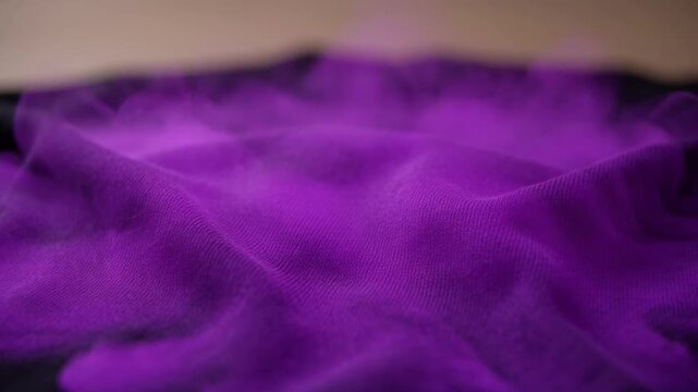 Thermochromic smart fabric changing color from black to purple under heat activation.