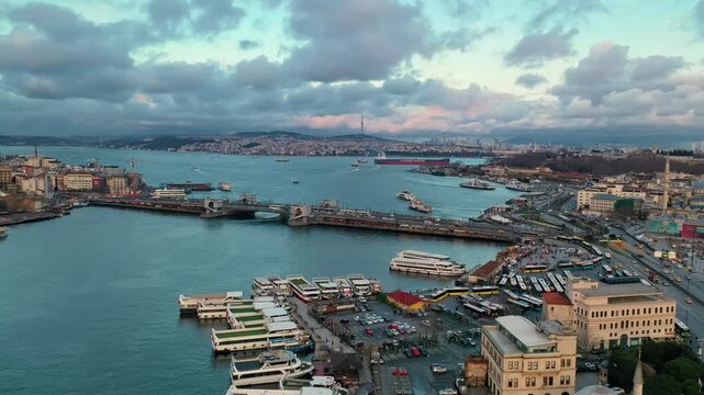 Aerial drone view of Eminonu and Halic Metro Bridge. Panoramic cityscape of Istanbul Golden Horn with historical peninsula landmarks at sunset.