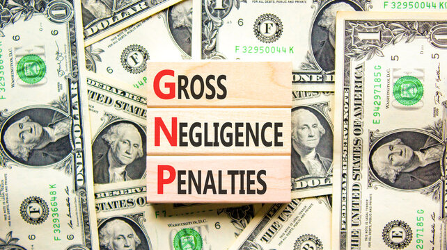 GNP gross negligence penalties symbol. Concept words GNP gross negligence penalties on beautiful wooden blocks. Beautiful dollar background. Business GNP gross negligence penalties concept. Copy space