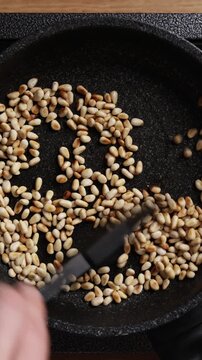 Stirring Pine Nuts Close Up Top View Vertical