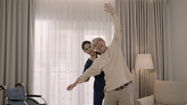 Professional beautiful Asian woman nurse physiotherapist helping senior man stretch arm and back for physiotherapy and rehabilitation of orthopedic conditions at hospital. Healthcare older concept. 