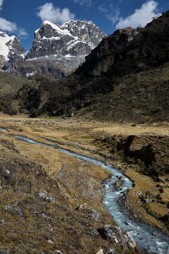 deep into the heart of Quebrada Carhuascancha, one of the most remote and rewarding valleys on the eastern flank of the Cordillera Blanca. The caravan moves in purposeful single file through an ancien