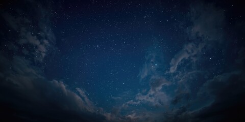 Fototapeta premium Night sky filled with stars and clouds