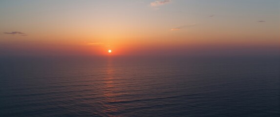 Fototapeta premium Ocean landscape at sunset from above with expansive open space and copy space area