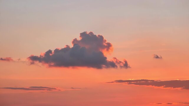 Vivid red sky at twilight featuring whimsical cloud shape