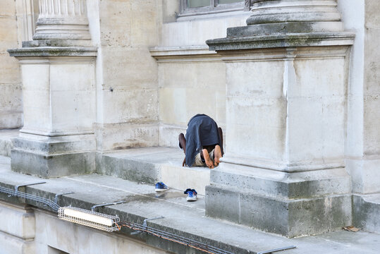 Man Praying in Public in Paris, France