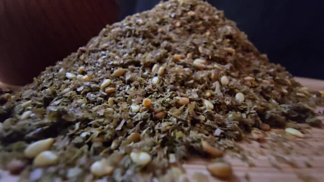 Close-up shot of a bowl filled with high-quality traditional za'atar spice mix, featuring toasted sesame seeds and aromatic dried herbs, gourmet middle eastern culinary ingredient, textured food backg