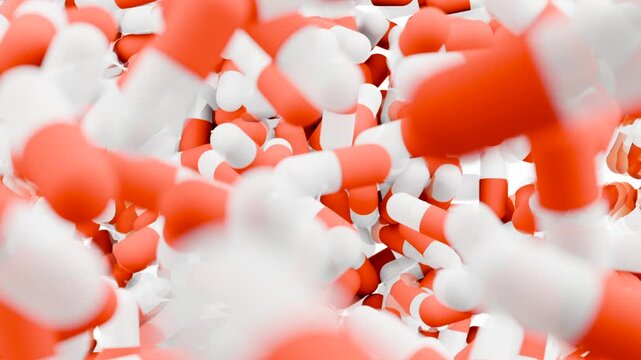 Orange and white capsules falling and filling the screen. 3D animation of medical pills. Pharmacy and healthcare concept.