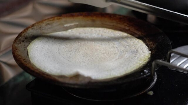 Making Traditional Indian Dosa Crepe on a Hot Cast Iron Tawa Pan