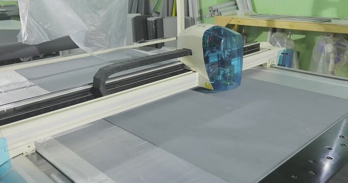 CNC Fabric Cutting Process in Modern Manufacturing Workshop. Automated Textile Cutting on CNC Plotter Machine.
