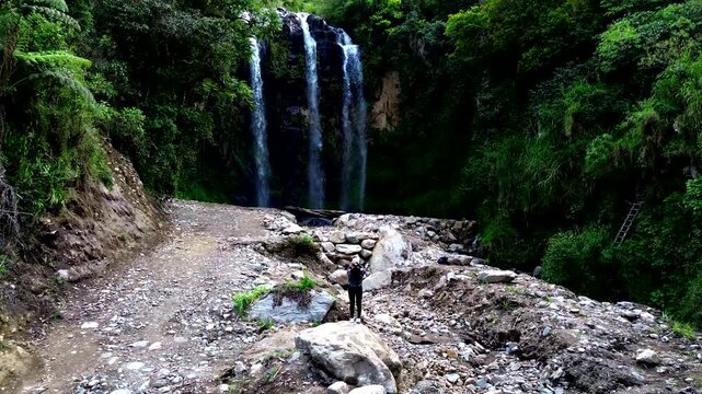 Wide View of Twin Waterfall in Ecuadorian Forest with Rocky Riverbed, Tourist, Green Canyon Walls and Scenic Tropical Andean Nature Travel Landscape