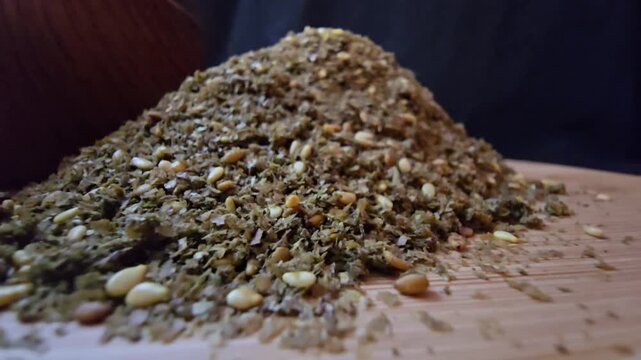 Close-up shot of a bowl filled with high-quality traditional za'atar spice mix, featuring toasted sesame seeds and aromatic dried herbs, gourmet middle eastern culinary ingredient, textured food backg