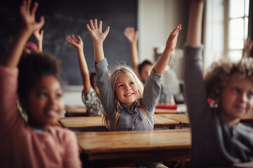 Fototapeta premium Enthusiastic school children actively raising their hands during a lesson in a bright classroom