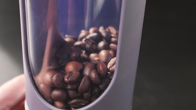 Macro view of roasted coffee beans inside a coffee machine or grinder hopper, highlighting rich textures, warm tones, and shallow depth of field.