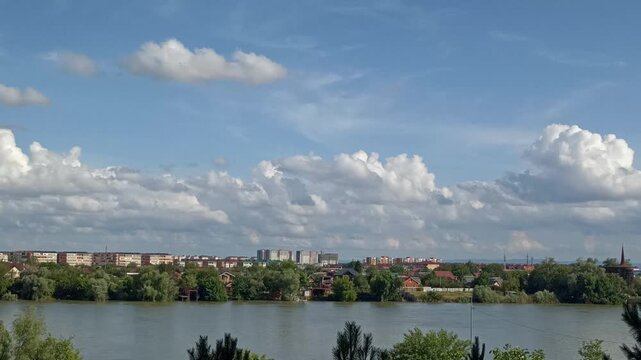 Timelapse: light cumulus clouds turn into thunderclouds and summer June rain over the wide Kuban River near Krasnodar, Southern Russia